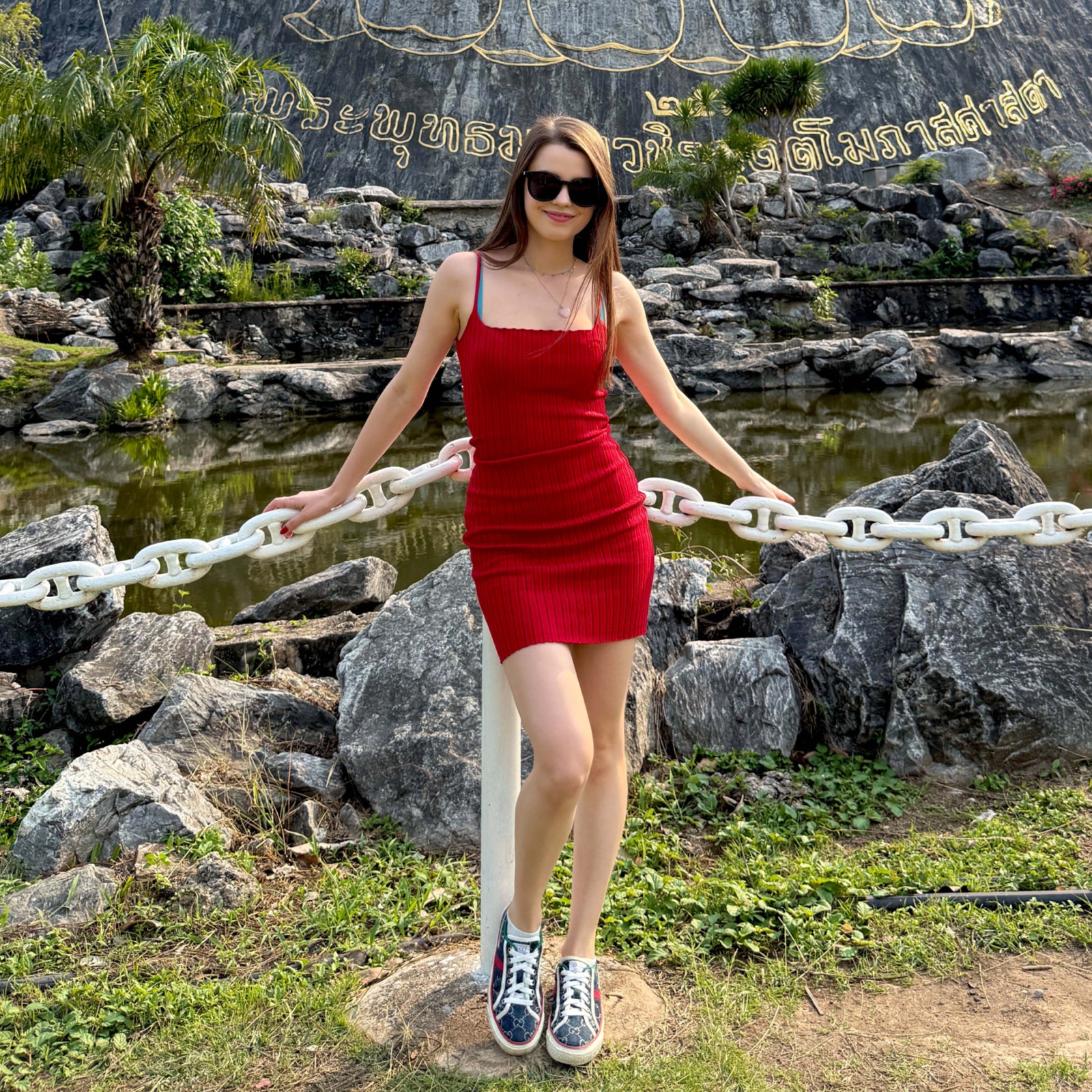 Jamie Young in a red dress while travelling